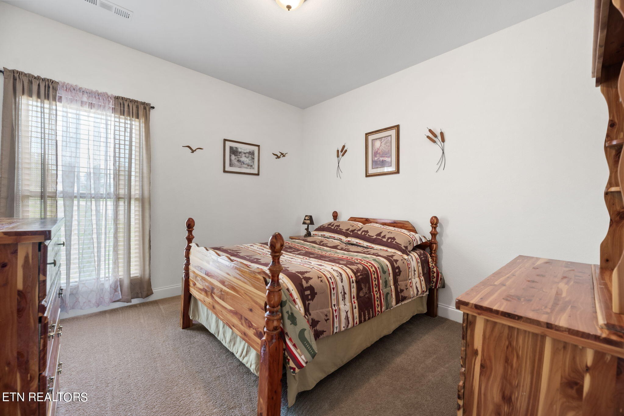 296 Shields Crossing Drive Bean Station, TN 37708 - Photo 19 of 52 a bed room with a bed and a chair