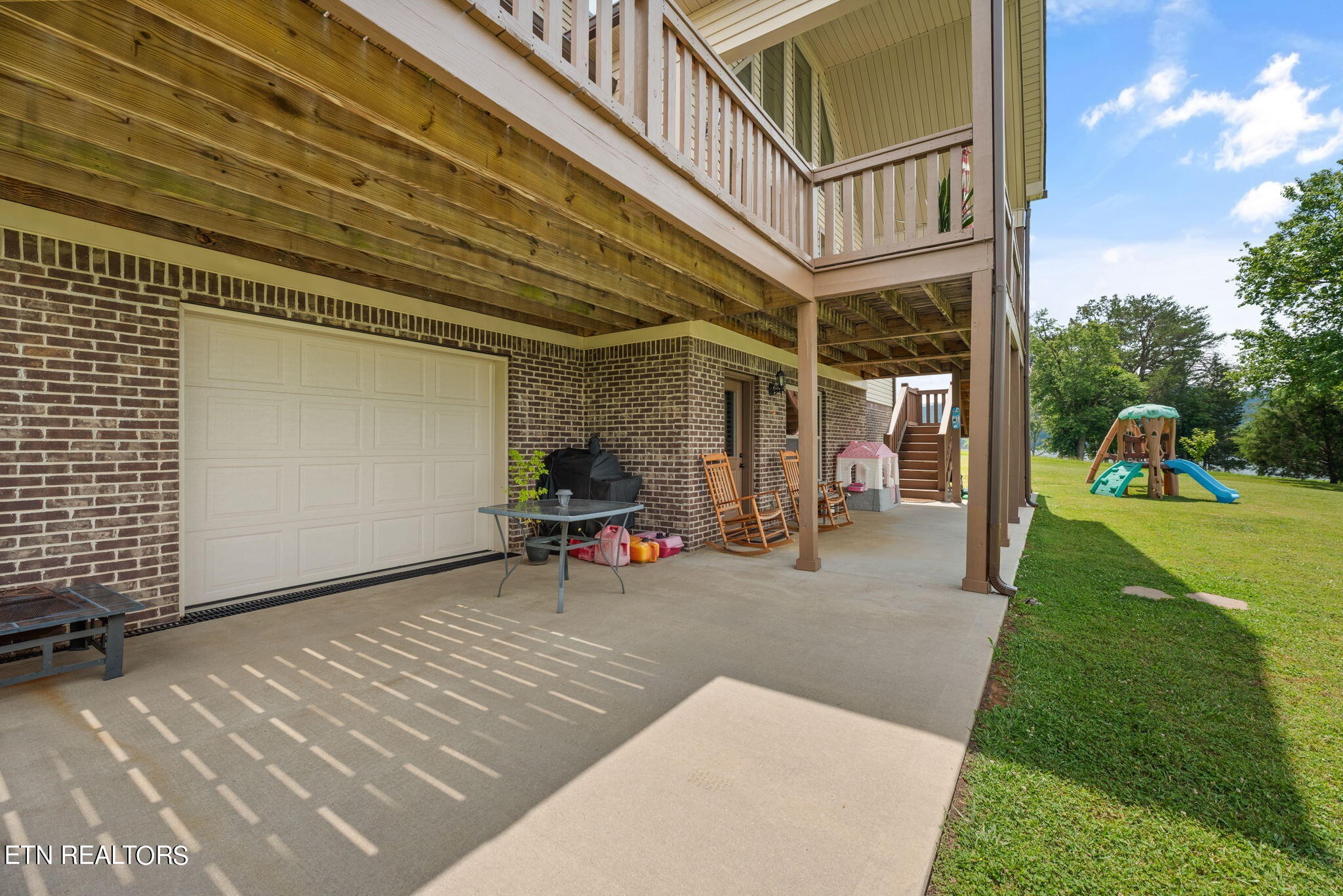 296 Shields Crossing Drive Bean Station, TN 37708 - Photo 37 of 52 a view of a porch with a table and chairs and potted plants