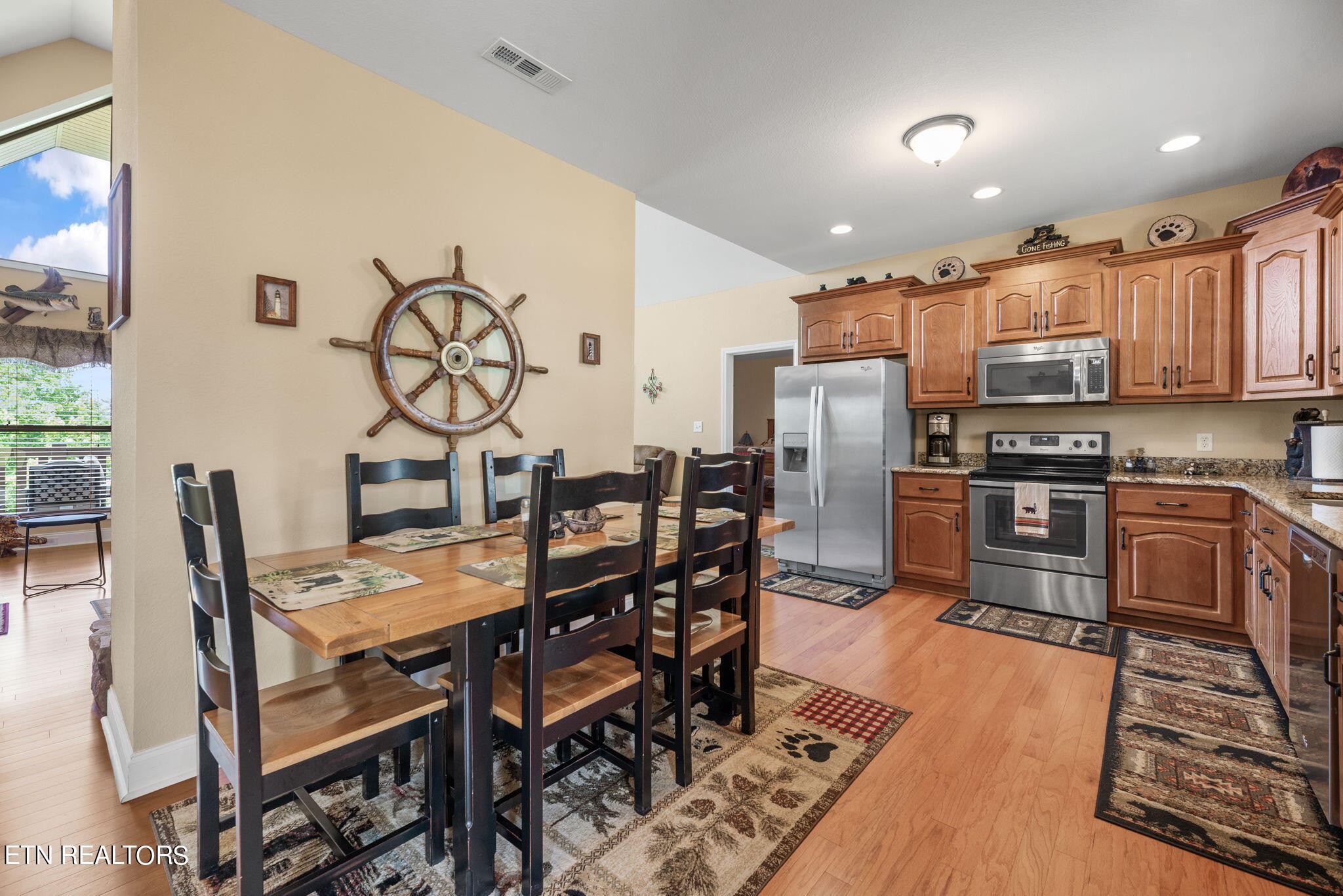 296 Shields Crossing Drive Bean Station, TN 37708 - Photo 10 of 52 a kitchen with stainless steel appliances kitchen island granite countertop a dining table chairs and granite counter tops