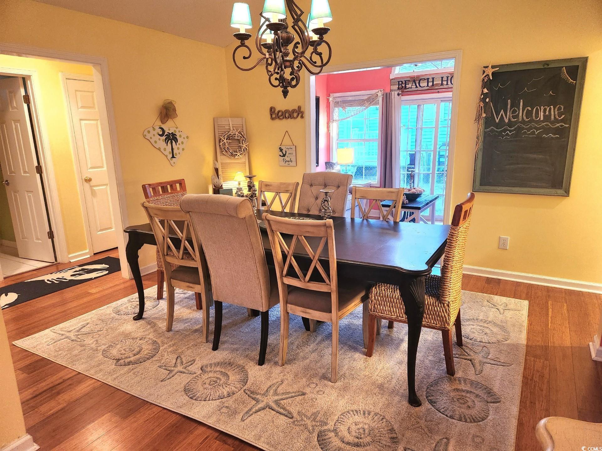 810 Marlin Court Murrells Inlet, SC 29576 - Photo 11 of 40 Dining space featuring a chandelier and wood finished floors