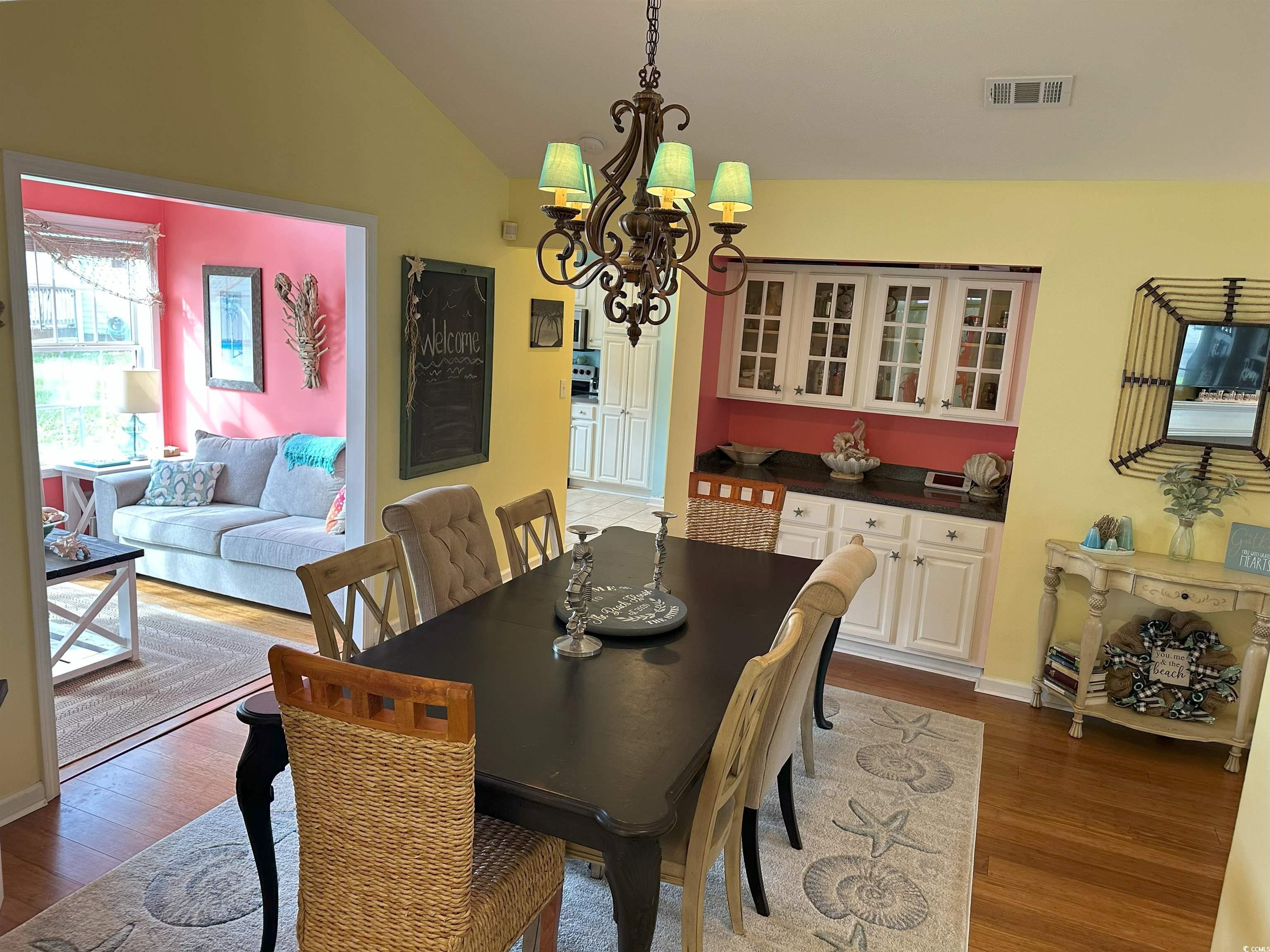 810 Marlin Court Murrells Inlet, SC 29576 - Photo 13 of 40 Dining area featuring wood finished floors, a chandelier, and lofted ceiling