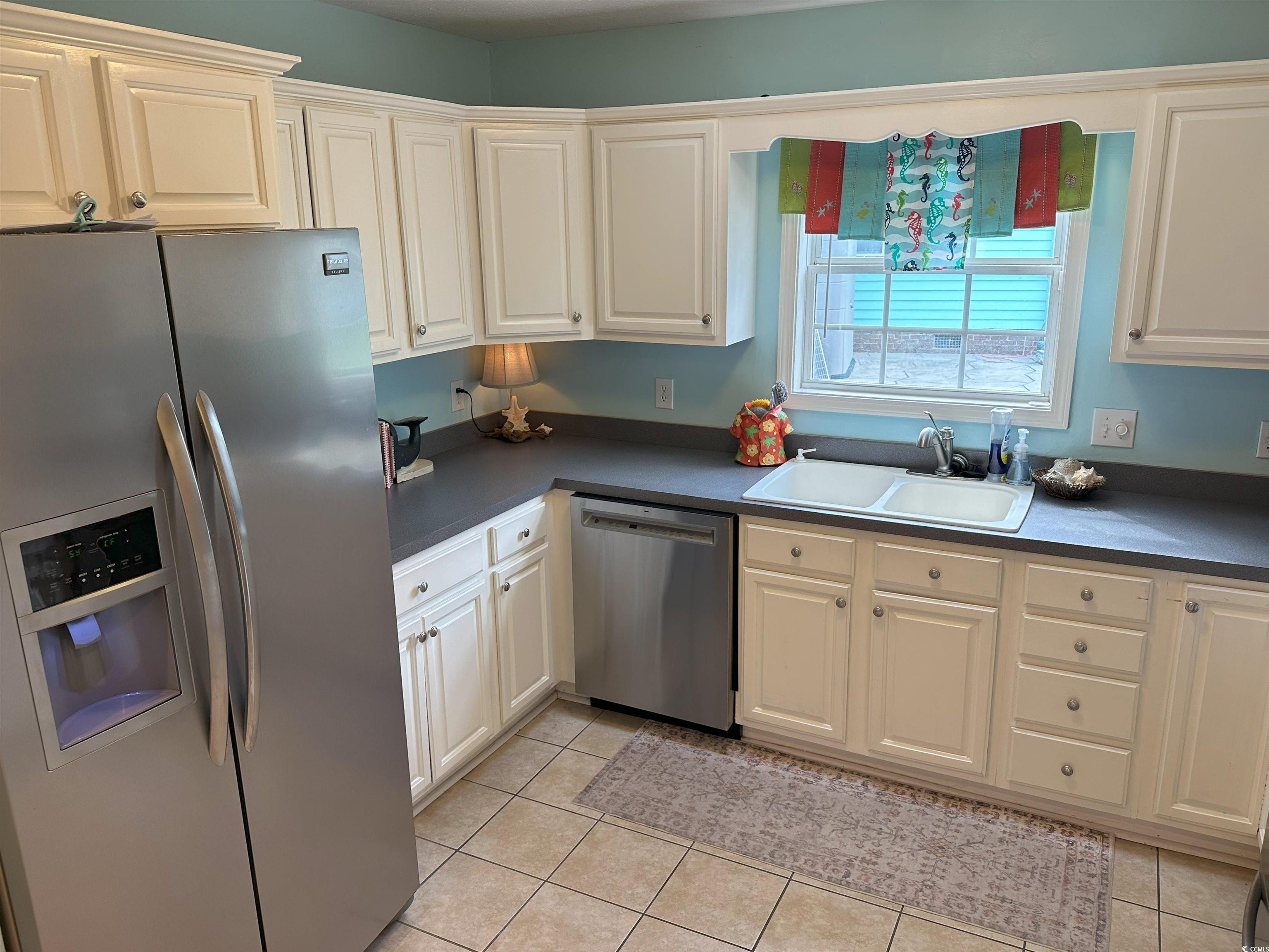 810 Marlin Court Murrells Inlet, SC 29576 - Photo 32 of 40 Kitchen featuring stainless steel appliances, light tile patterned flooring, and dark countertops