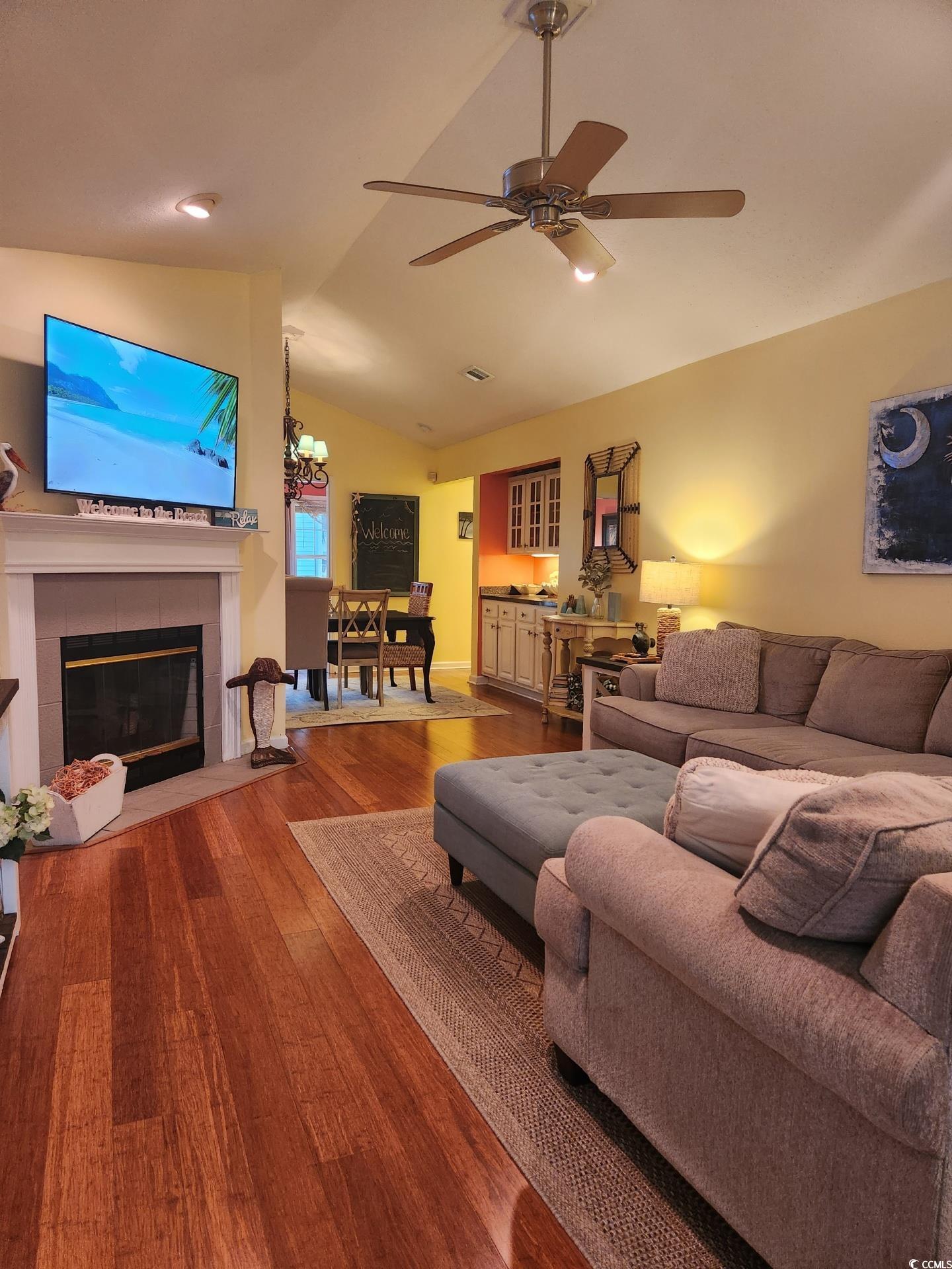 810 Marlin Court Murrells Inlet, SC 29576 - Photo 5 of 40 Living area featuring vaulted ceiling, wood finished floors, a tiled fireplace, ceiling fan, and recessed lighting