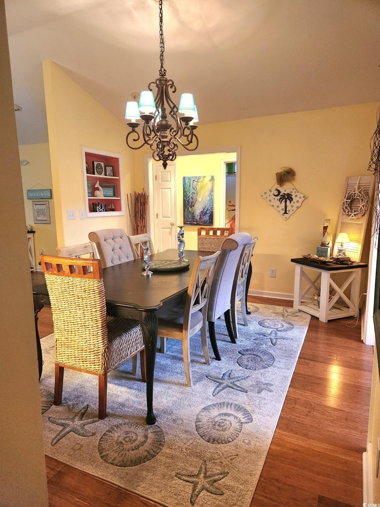 810 Marlin Court Murrells Inlet, SC 29576 - Photo 10 of 40 Dining space with a chandelier and wood finished floors
