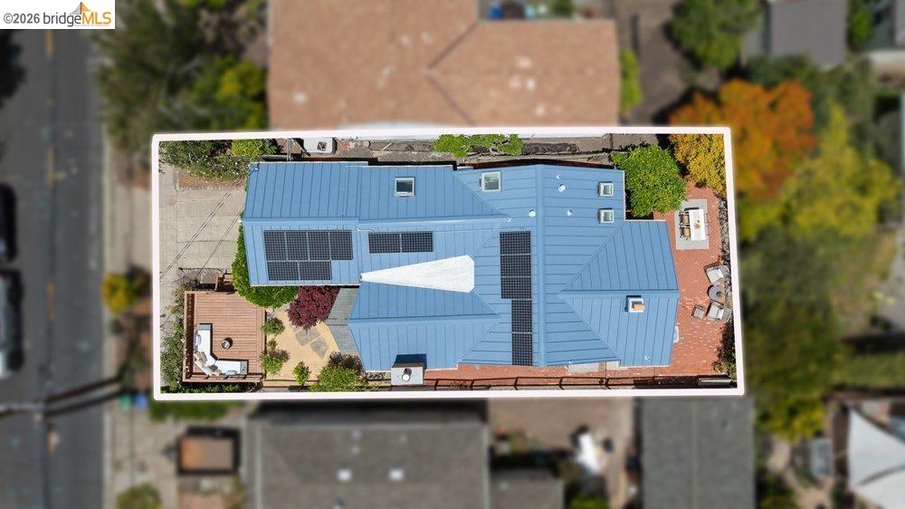 287 Purdue Avenue Kensington, CA 94708 - Photo 59 of 60 Modern roofline featuring a blue metal roof with multiple solar panel arrays