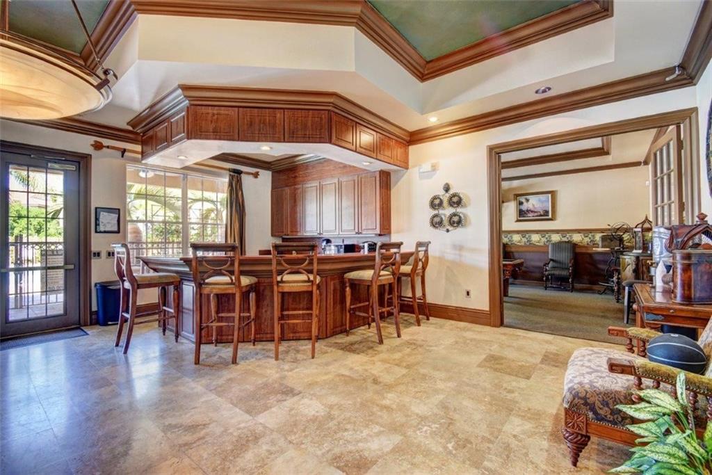 1312 Villa Lane, Unit 1312 Boynton Beach, FL 33435 - Photo 18 of 34 a view of a dining hall with lots of furniture and wooden floor