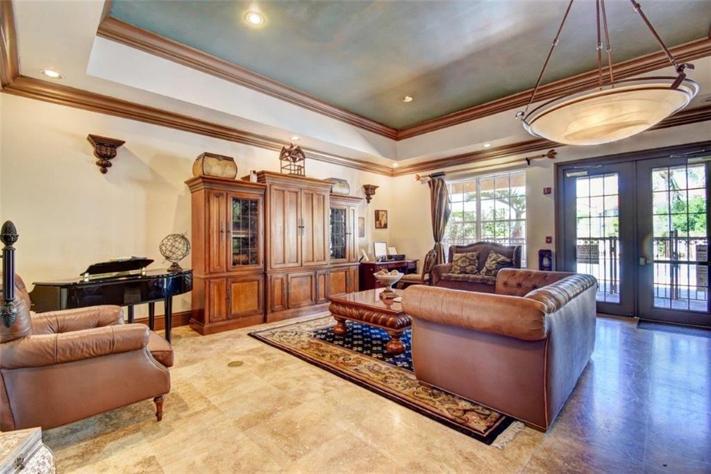 1312 Villa Lane, Unit 1312 Boynton Beach, FL 33435 - Photo 19 of 34 a living room with furniture and a chandelier