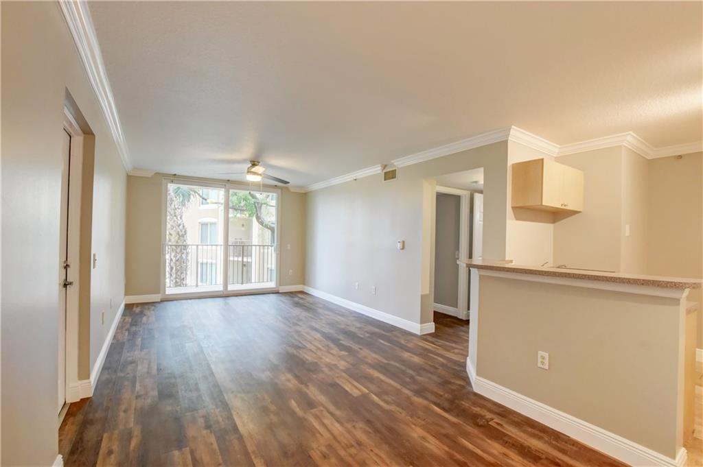 1312 Villa Lane, Unit 1312 Boynton Beach, FL 33435 - Photo 23 of 34 a view of an empty room with wooden floor and a window