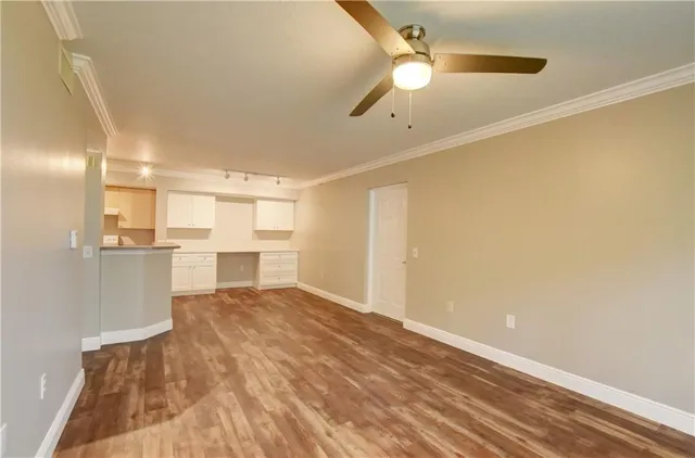 a view of a kitchen with a sink and cabinets