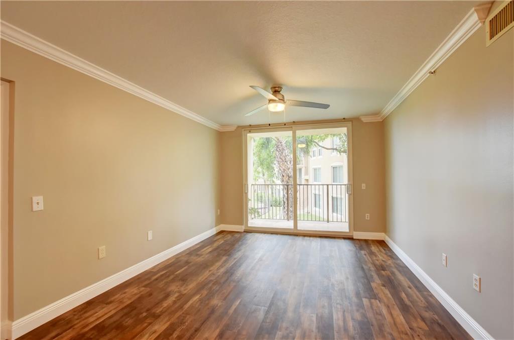 1312 Villa Lane, Unit 1312 Boynton Beach, FL 33435 - Photo 25 of 34 a view of an empty room with a window and wooden floor