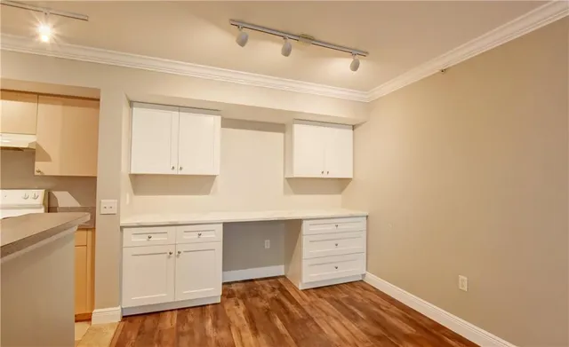 a room with window and white cabinets