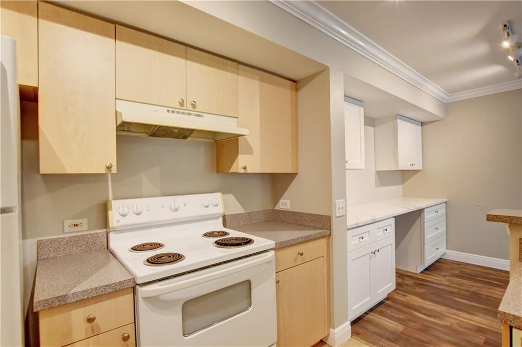 1312 Villa Lane, Unit 1312 Boynton Beach, FL 33435 - Photo 30 of 34 a kitchen with white cabinets and white appliances