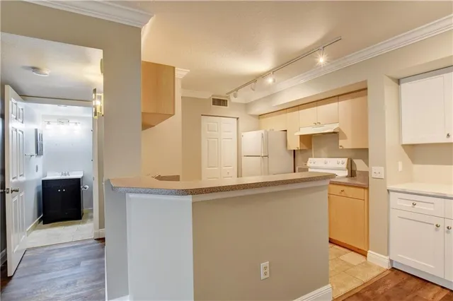 a kitchen with stainless steel appliances granite countertop a sink and cabinets