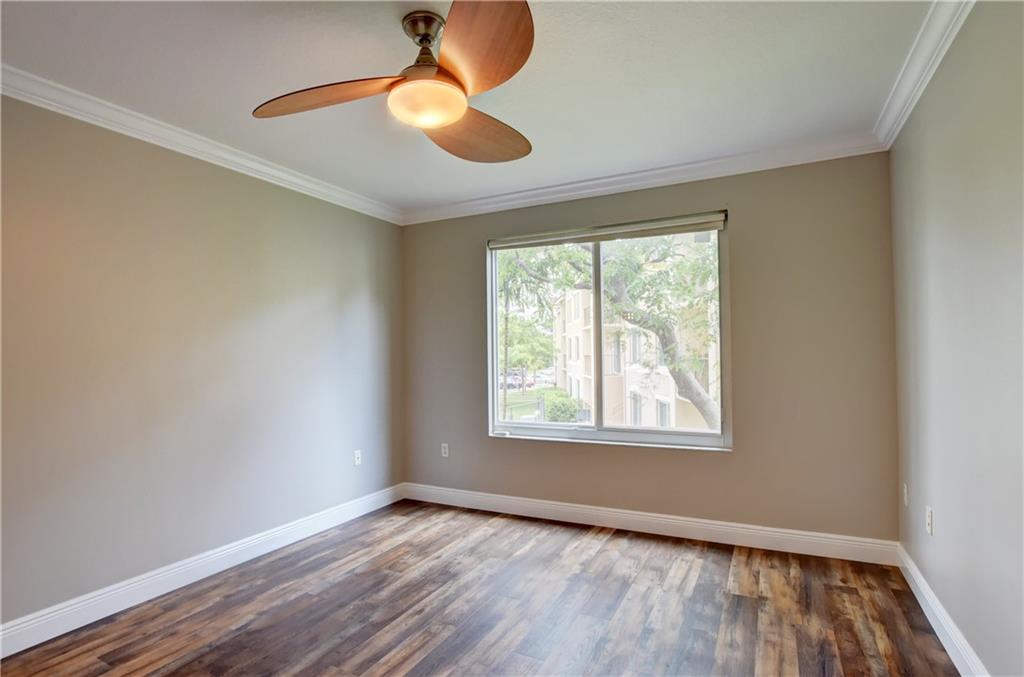 1312 Villa Lane, Unit 1312 Boynton Beach, FL 33435 - Photo 32 of 34 a view of an empty room with wooden floor and a window