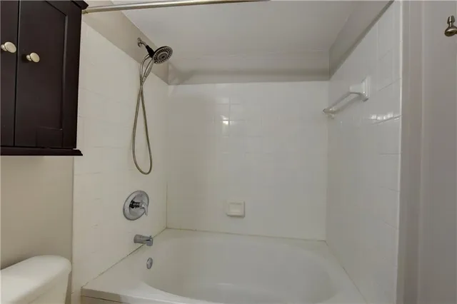 a bathroom with a bath tub with a shower