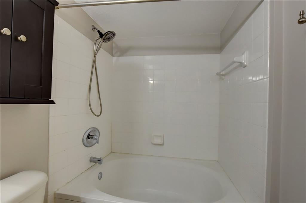 1312 Villa Lane, Unit 1312 Boynton Beach, FL 33435 - Photo 33 of 34 a bathroom with a bath tub with a shower