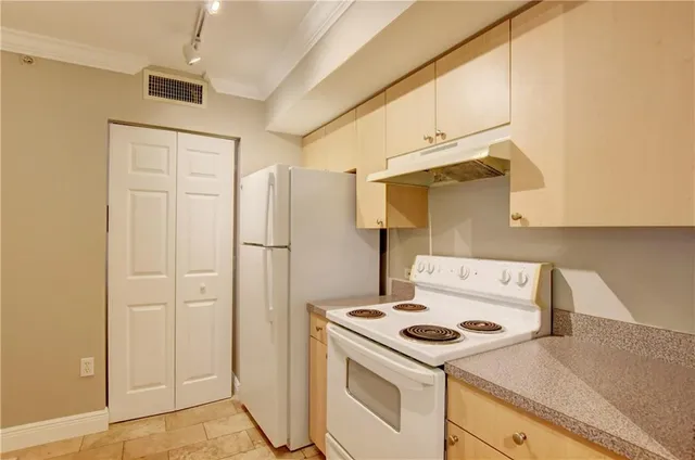 a kitchen with a stove and a refrigerator