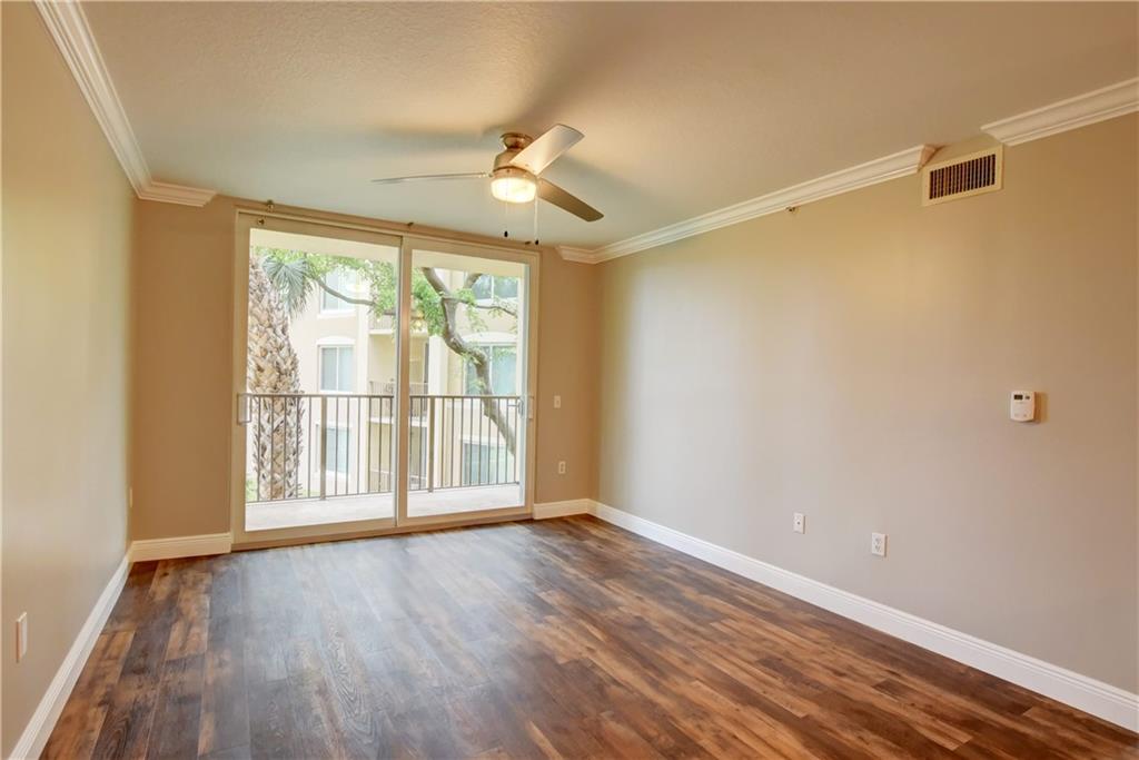1312 Villa Lane, Unit 1312 Boynton Beach, FL 33435 - Photo 6 of 34 a view of an empty room with wooden floor and a window