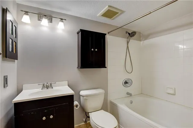 a bathroom with a sink vanity mirror and shower