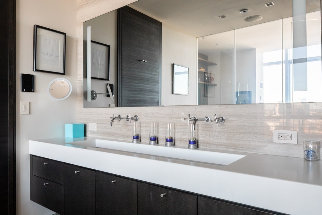 110 Stuart Street, Unit PH04 Boston, MA 02116 - Photo 16 of 36 a bathroom with a sink and a mirror