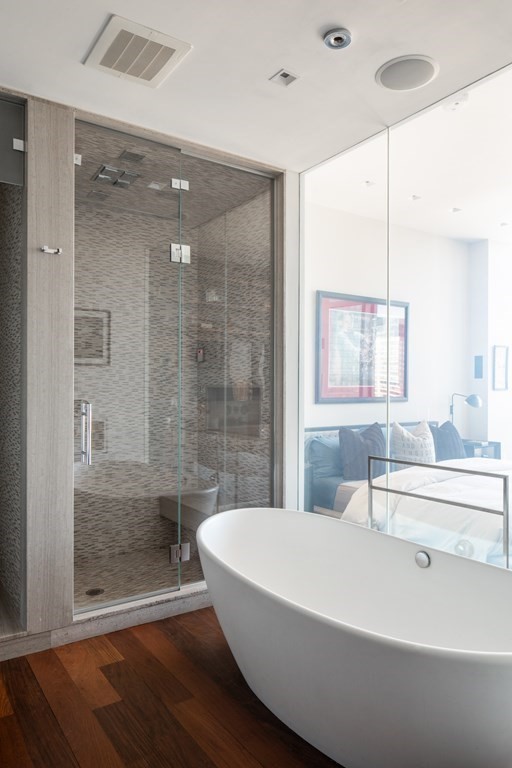 110 Stuart Street, Unit PH04 Boston, MA 02116 - Photo 17 of 36 a bathroom with a bathtub and a shower