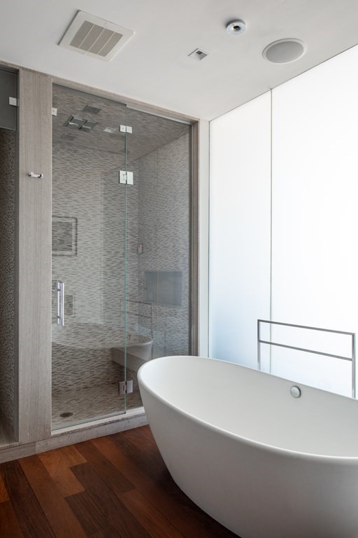110 Stuart Street, Unit PH04 Boston, MA 02116 - Photo 18 of 36 a bathroom with a bathtub and a shower