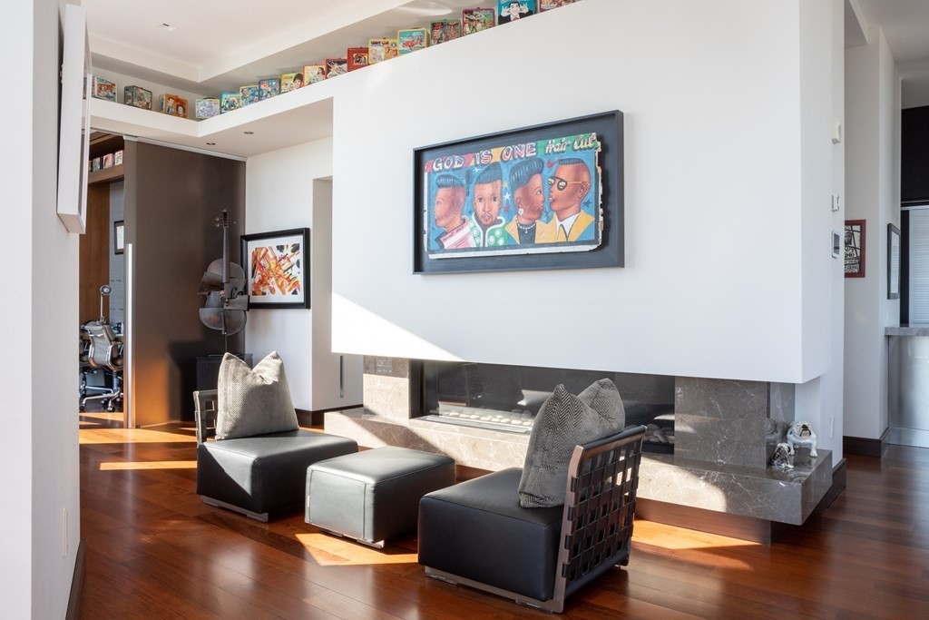 110 Stuart Street, Unit PH04 Boston, MA 02116 - Photo 6 of 36 a living room with furniture and a wooden floor