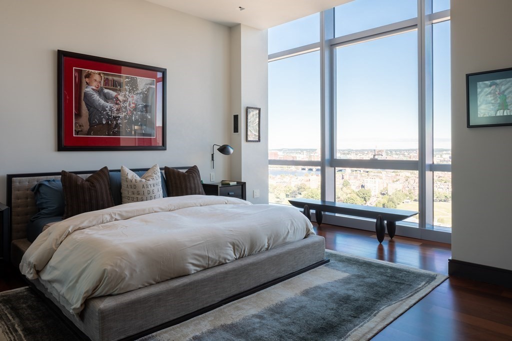 110 Stuart Street, Unit PH04 Boston, MA 02116 - Photo 9 of 36 a bed sitting in a bedroom next to a window