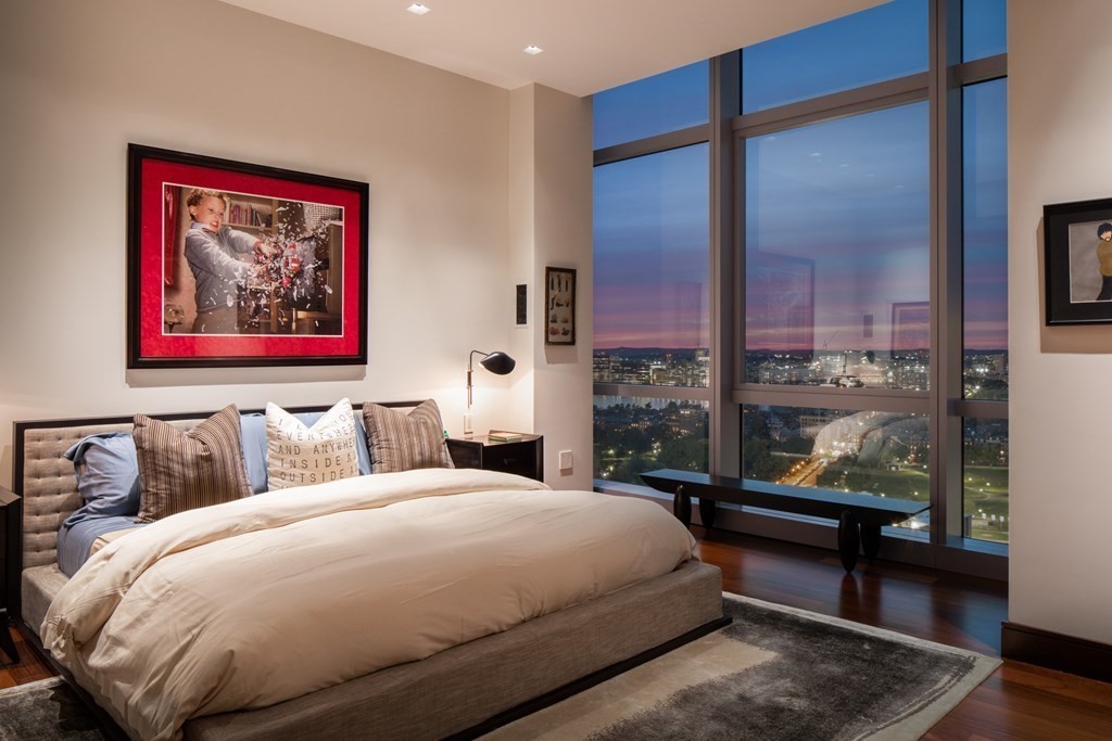 110 Stuart Street, Unit PH04 Boston, MA 02116 - Photo 10 of 36 a bedroom with a bed and a painting on the wall