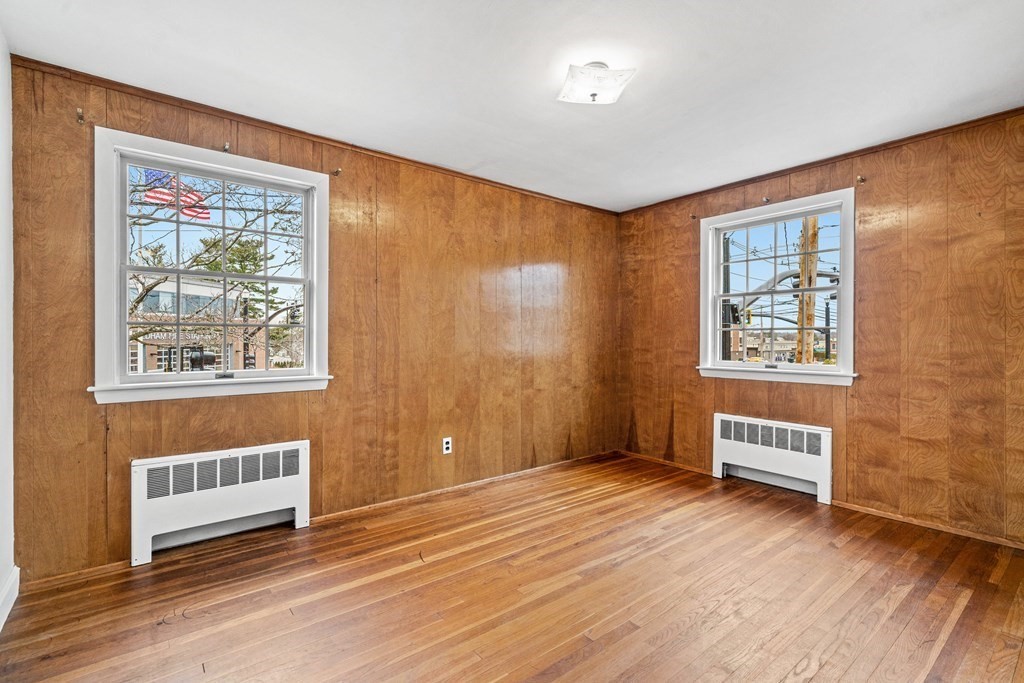 277 Webster Street Needham, MA 02494 - Photo 13 of 17 a view of an empty room with a window and wooden floor