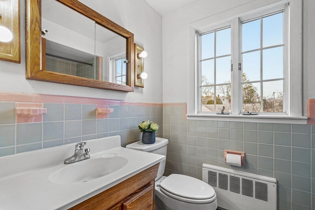 277 Webster Street Needham, MA 02494 - Photo 14 of 17 a bathroom with a sink a toilet and a mirror