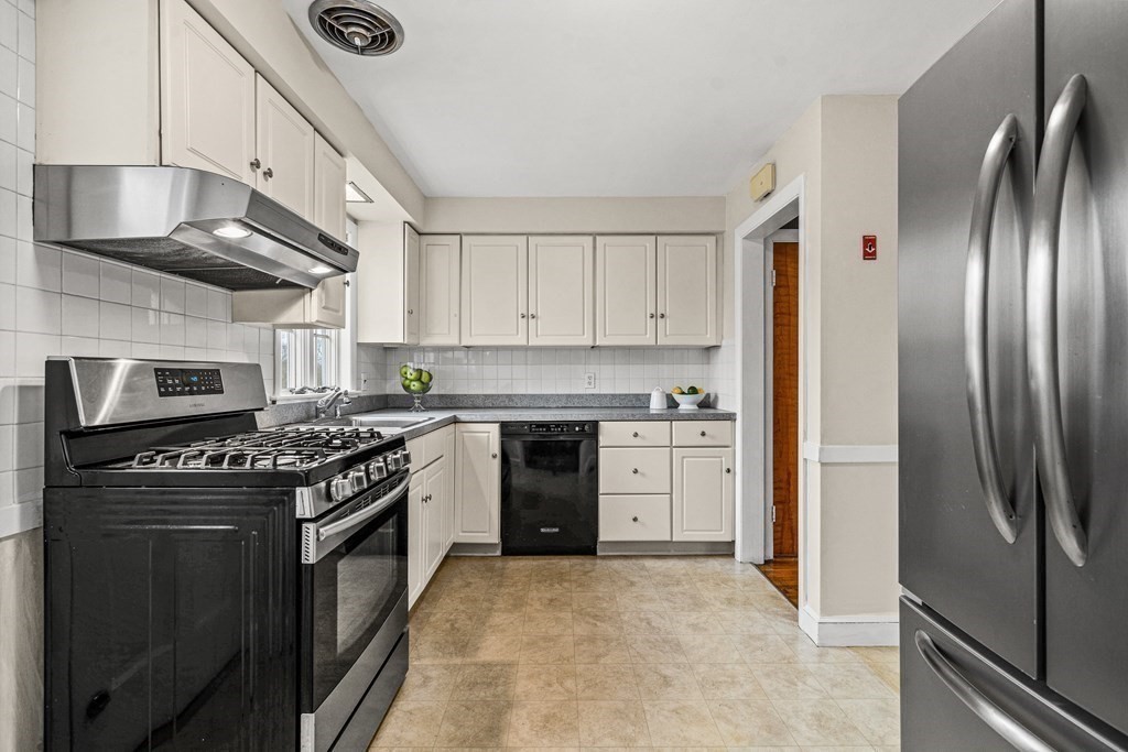 277 Webster Street Needham, MA 02494 - Photo 8 of 17 a kitchen with stainless steel appliances granite countertop a stove and a refrigerator