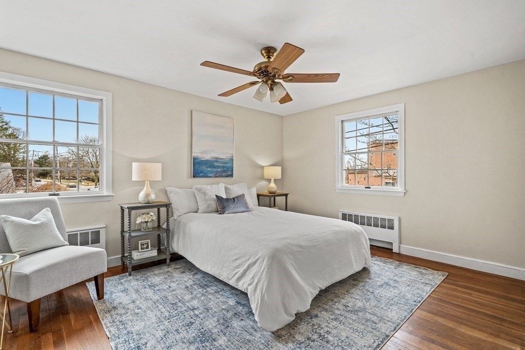 277 Webster Street Needham, MA 02494 - Photo 10 of 17 a bedroom with a large bed a chandelier and windows