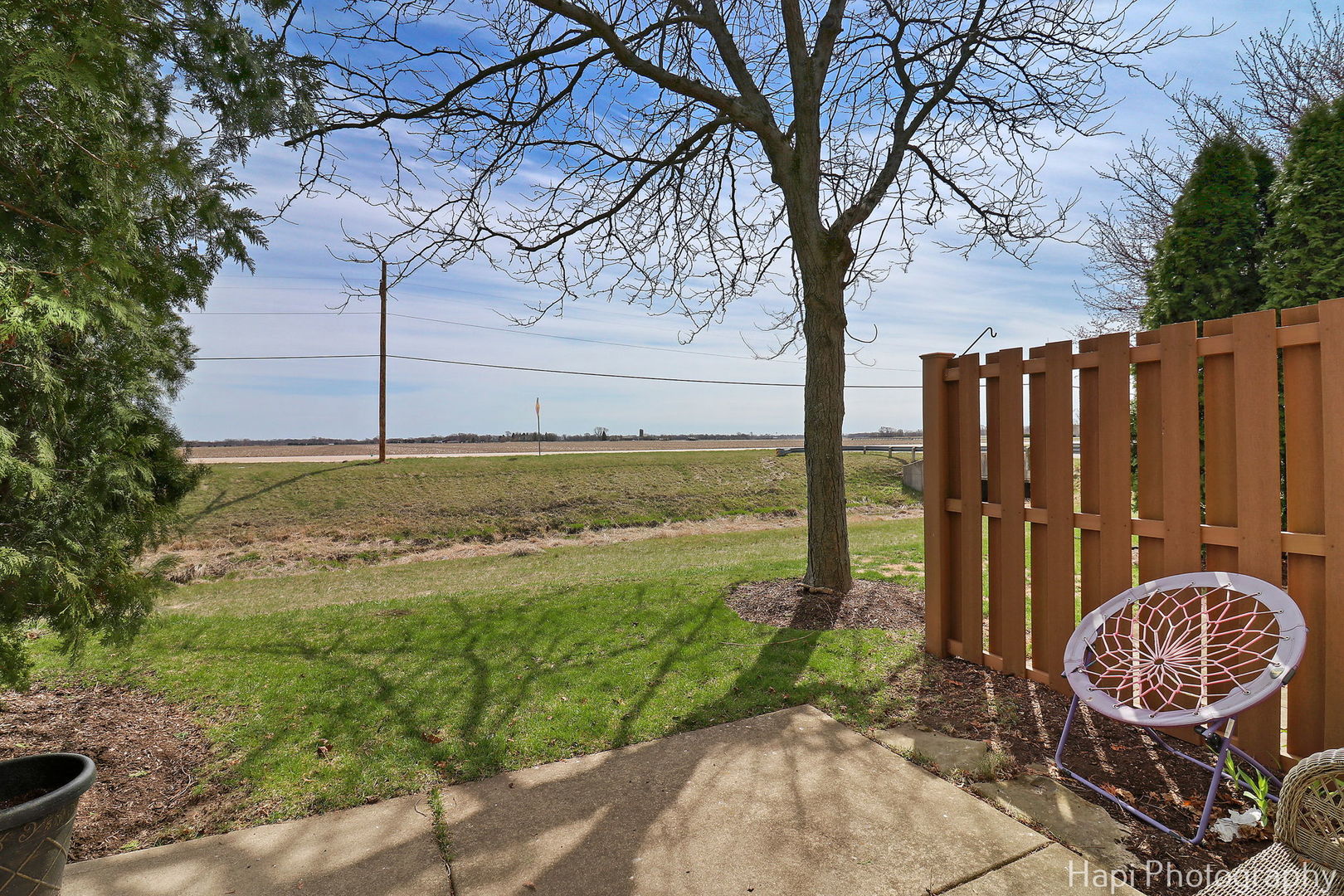 809 Village Circle Marengo, IL 60152 - Photo 17 of 19 a view of a backyard with wooden fence