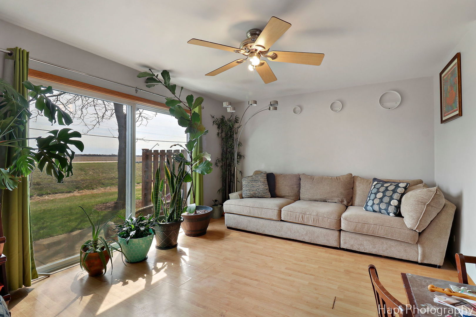809 Village Circle Marengo, IL 60152 - Photo 8 of 19 a living room with furniture potted plant and a large window