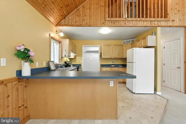 a kitchen with a refrigerator and a sink