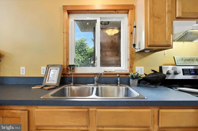 a kitchen with a refrigerator a stove and a sink
