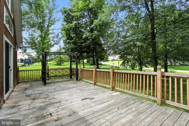 a view of balcony with wooden floor and fence