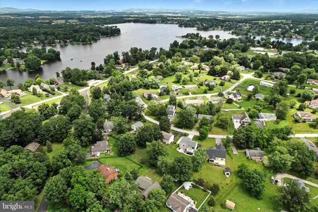 an aerial view of a houses with a yard