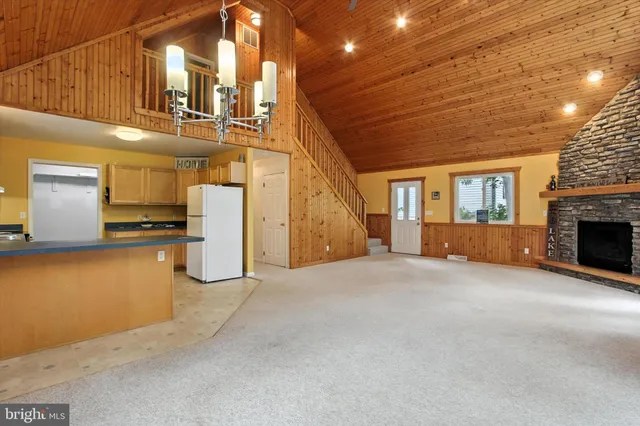 a view of backyard with a barn and a large tree
