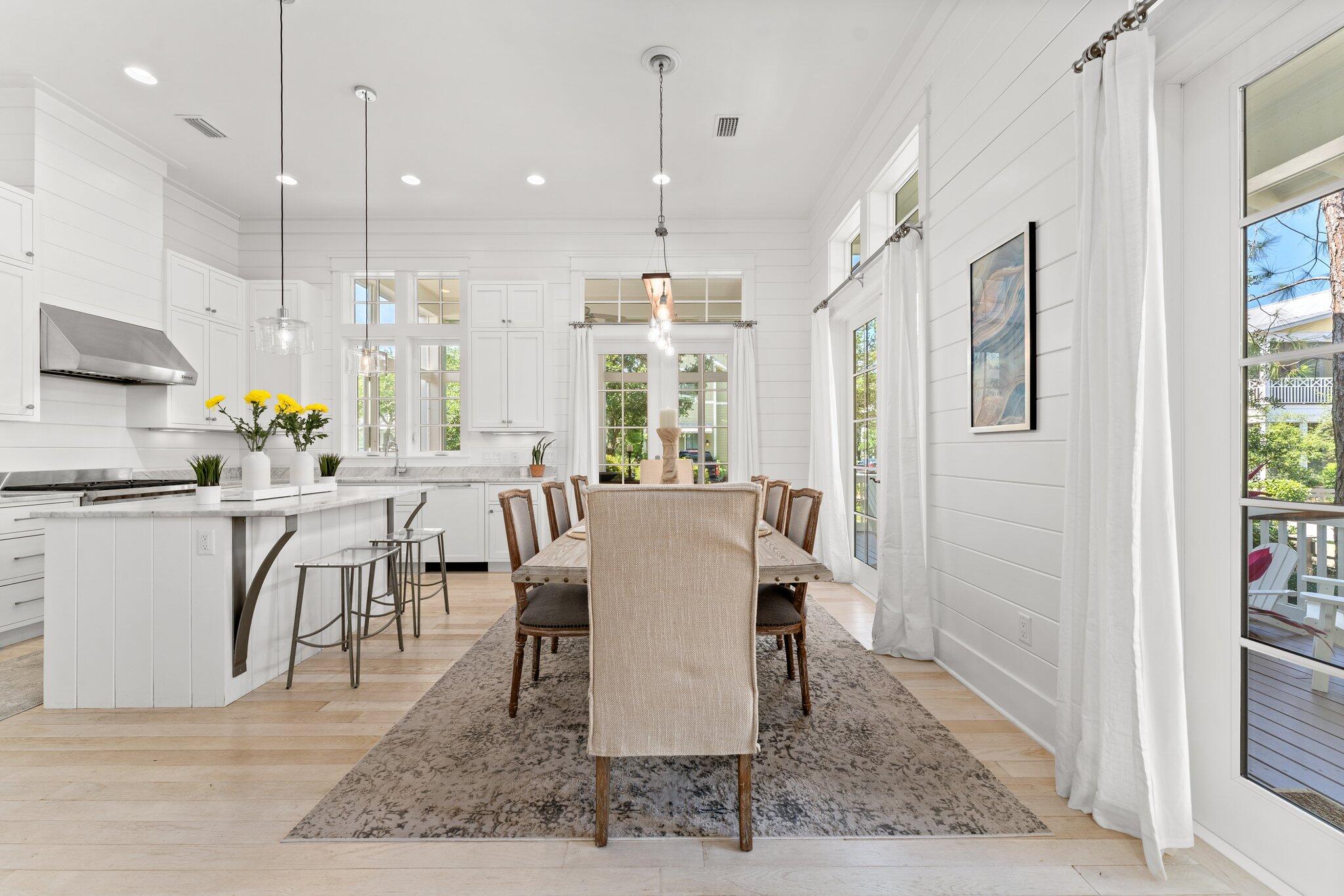 56 South Wisteria Way Santa Rosa Beach, FL 32459 - Photo 14 of 77 a large kitchen with a table and chairs