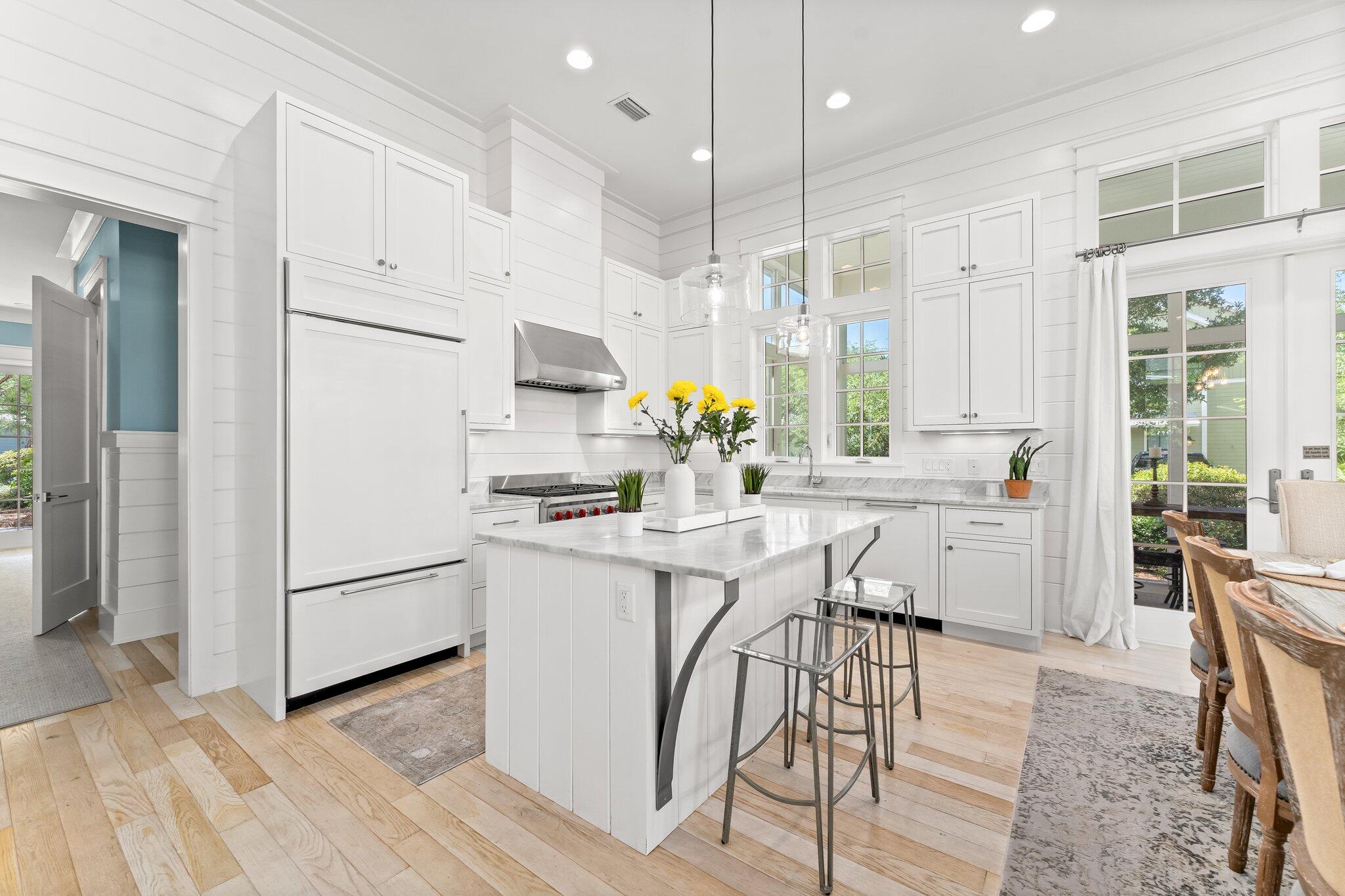 56 South Wisteria Way Santa Rosa Beach, FL 32459 - Photo 15 of 77 a kitchen with stainless steel appliances white cabinets and wooden floors