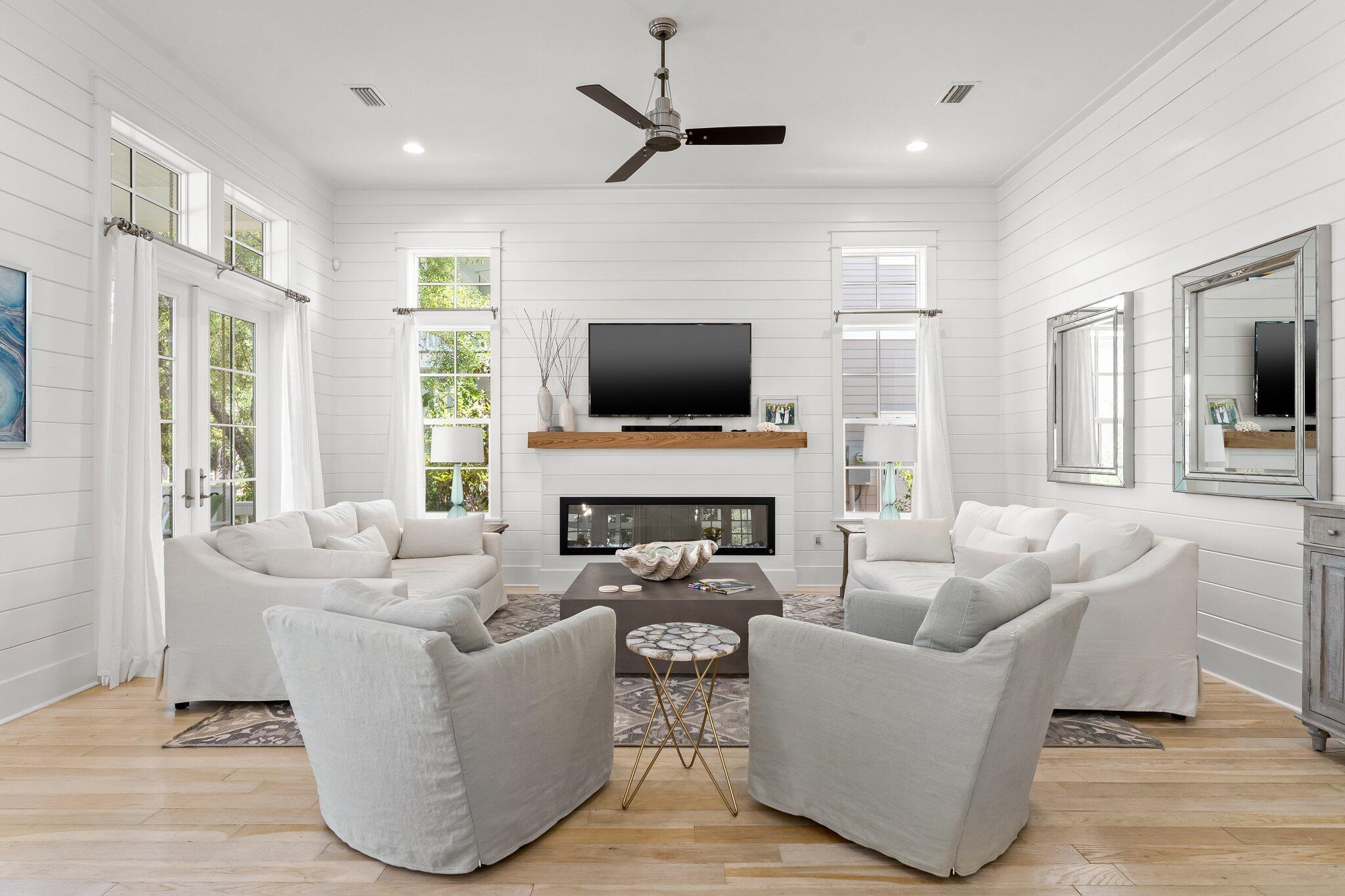 56 South Wisteria Way Santa Rosa Beach, FL 32459 - Photo 19 of 77 a living room with furniture a fireplace and a flat screen tv