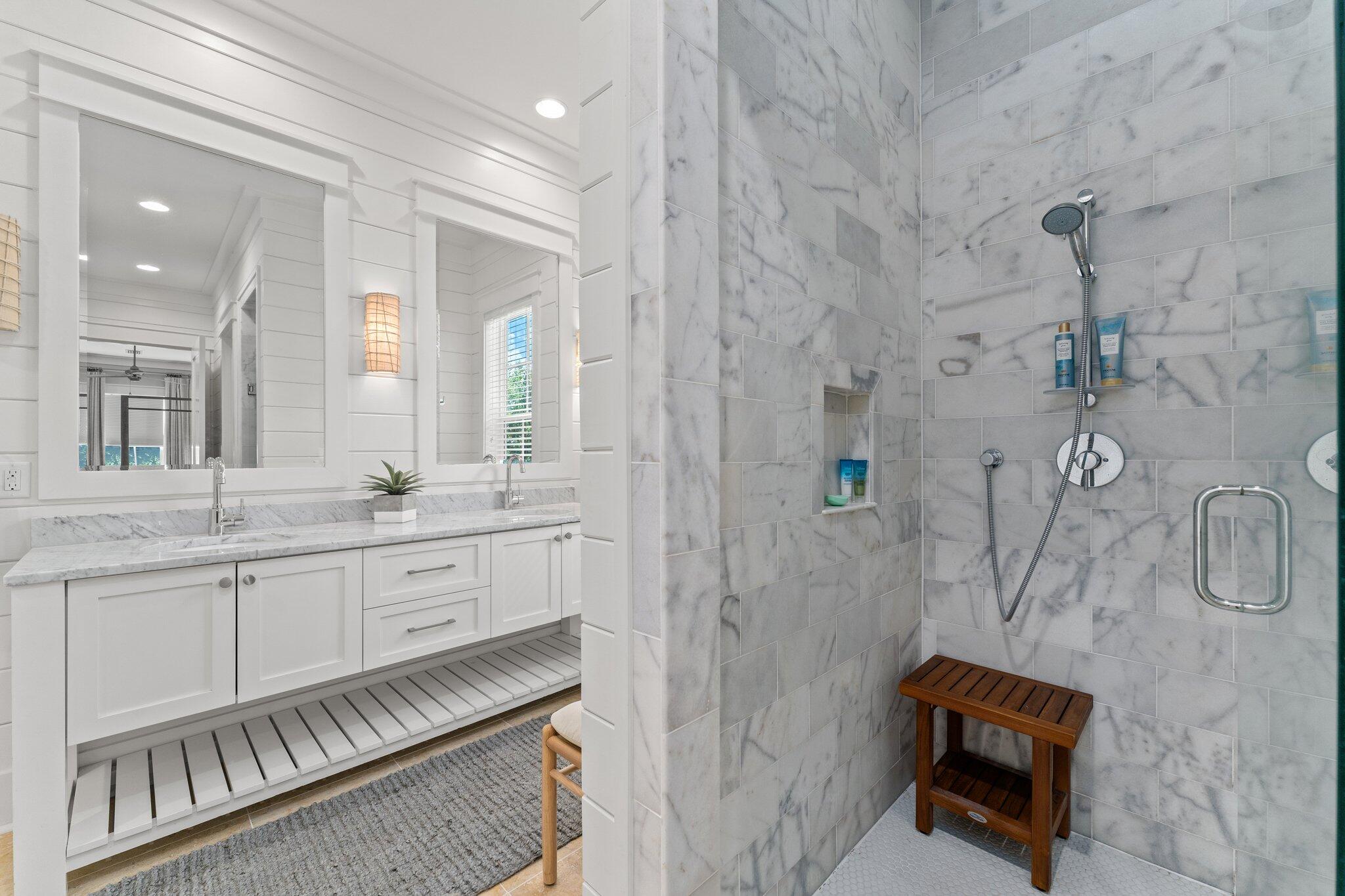 56 South Wisteria Way Santa Rosa Beach, FL 32459 - Photo 27 of 77 a bathroom with a double vanity sink a toilet a mirror and shower