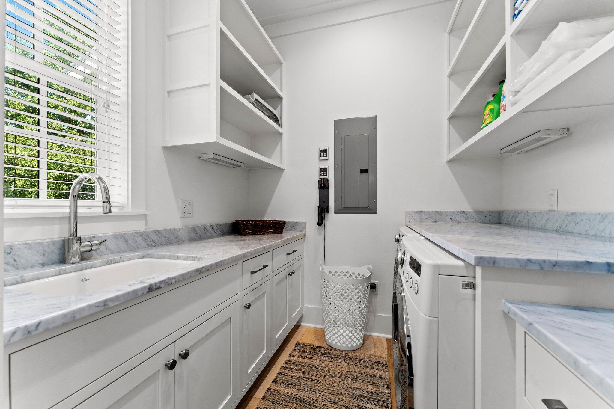 56 South Wisteria Way Santa Rosa Beach, FL 32459 - Photo 32 of 77 a kitchen with a sink and cabinets