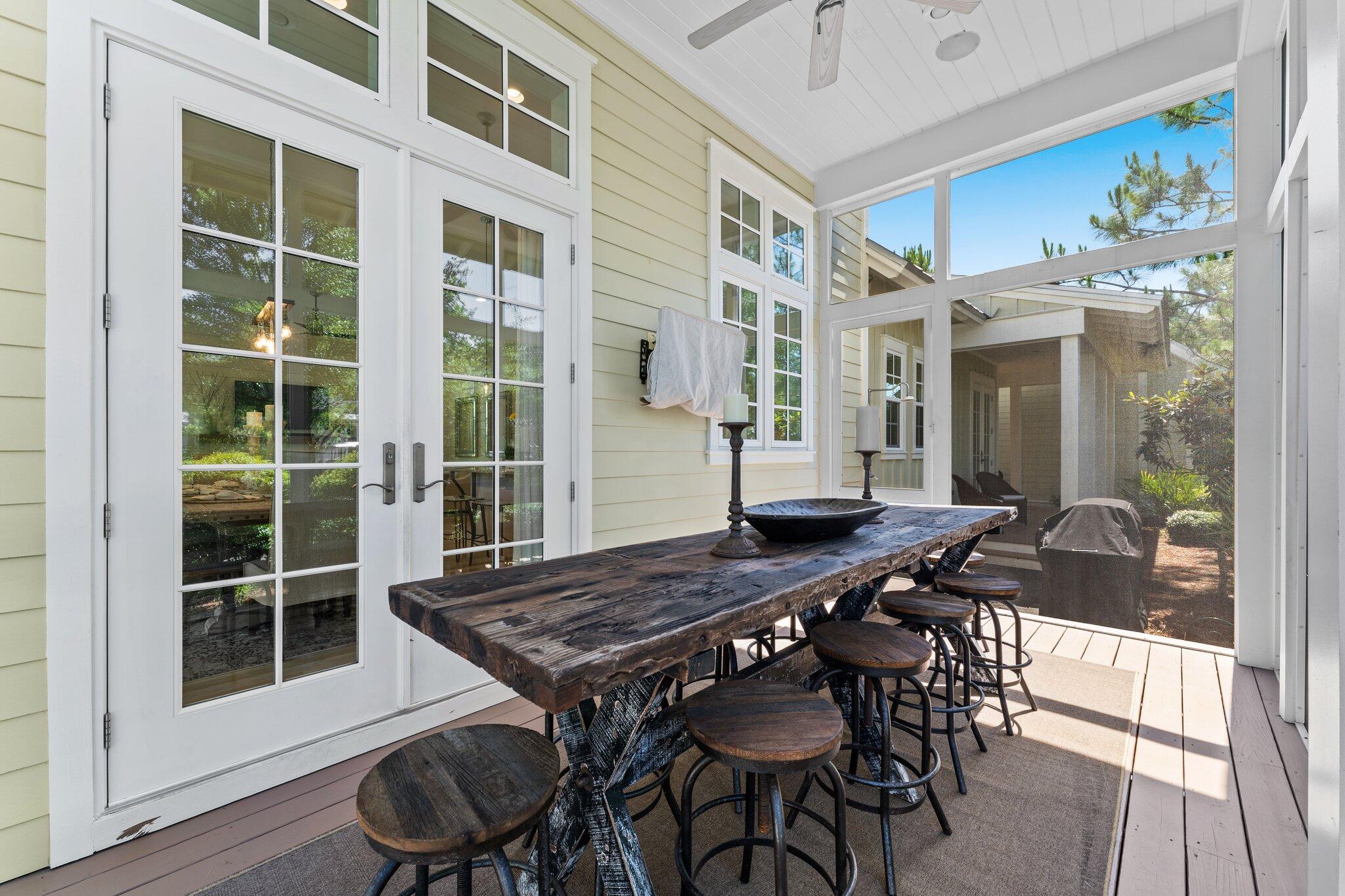 56 South Wisteria Way Santa Rosa Beach, FL 32459 - Photo 36 of 77 a view of a dinning table and chairs in patio of the house