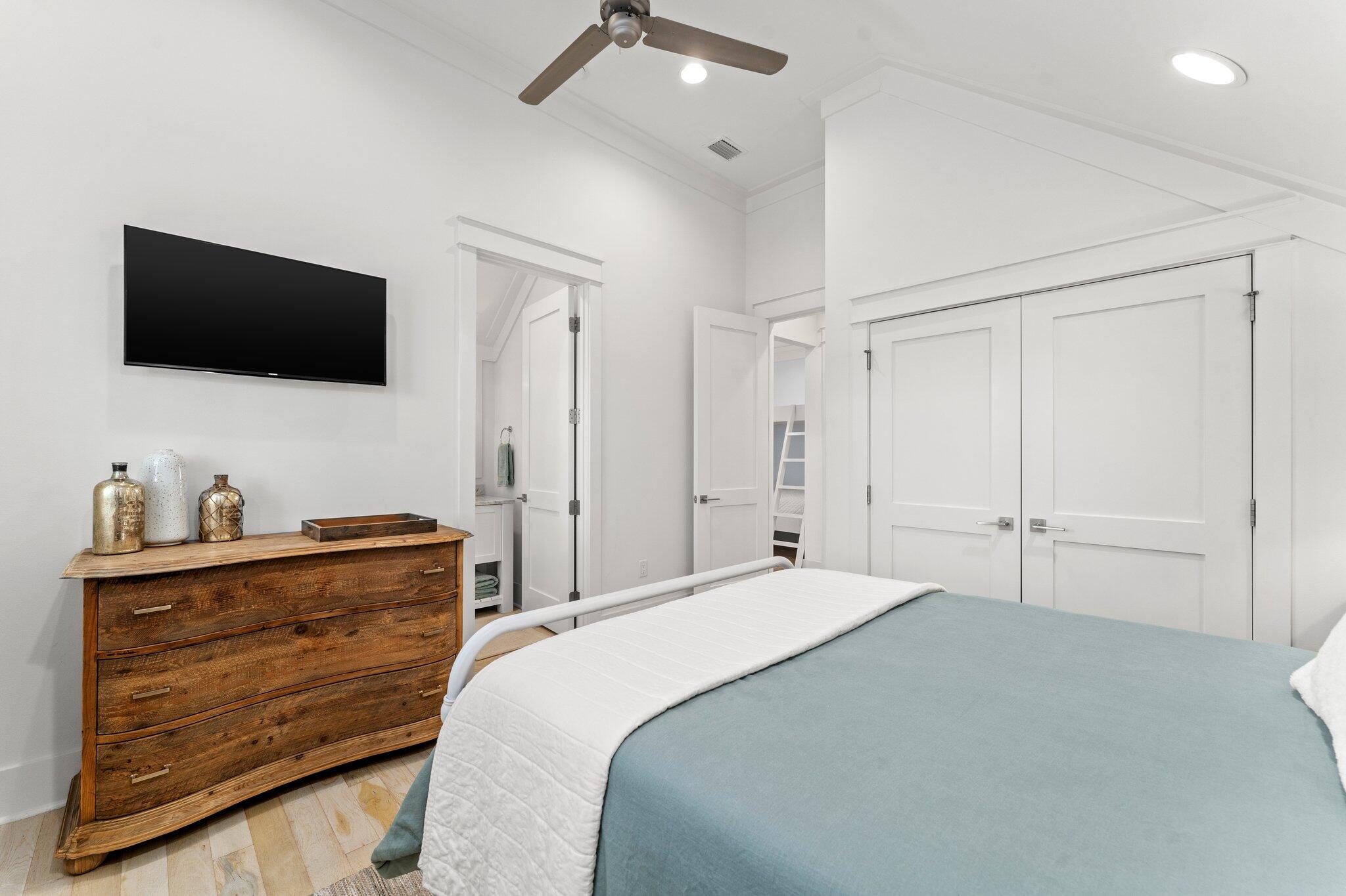 56 South Wisteria Way Santa Rosa Beach, FL 32459 - Photo 45 of 77 a bedroom with a bed and a flat screen tv