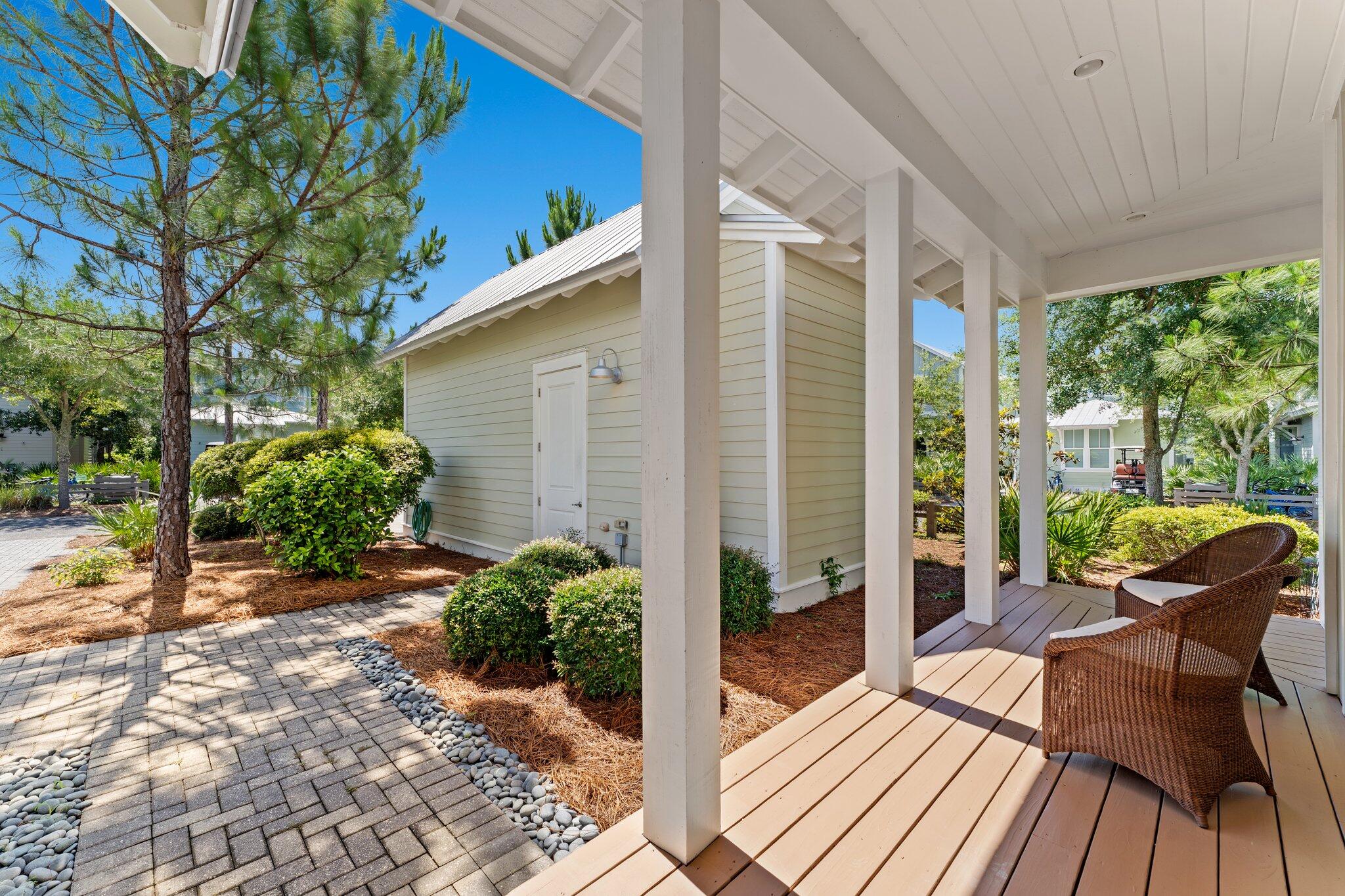 56 South Wisteria Way Santa Rosa Beach, FL 32459 - Photo 50 of 77 a view of a patio with table and chairs potted plants with wooden floor