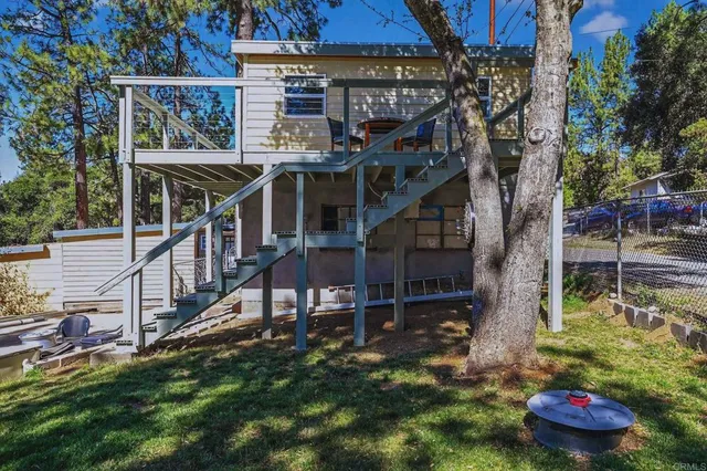 a view of house with a swimming pool