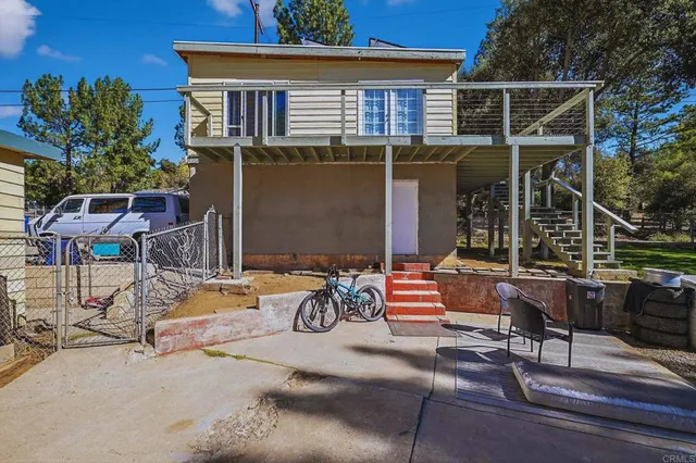 a backyard of a house with table and chairs